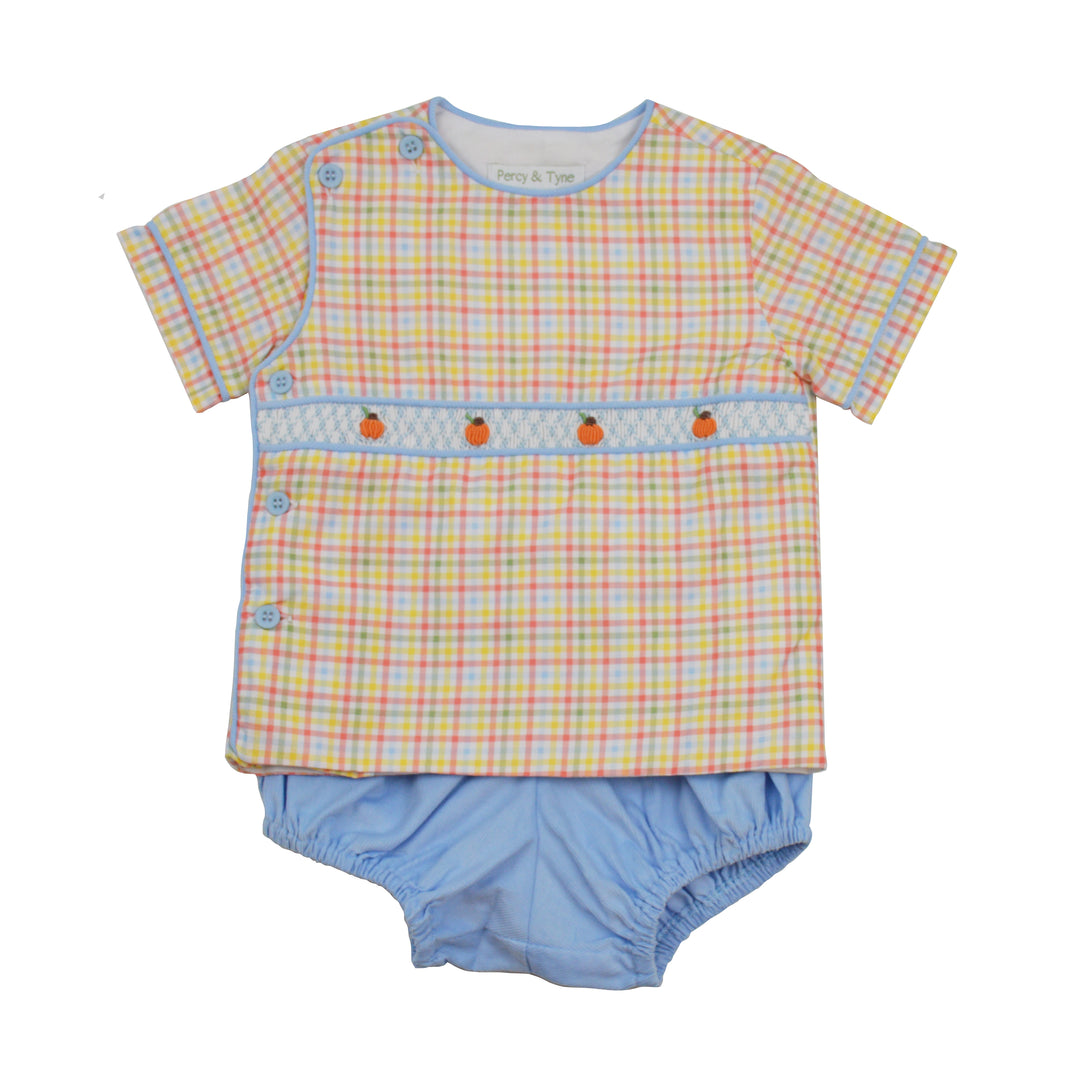 Baby outfit with checkered shirt and blue bloomers on a white background