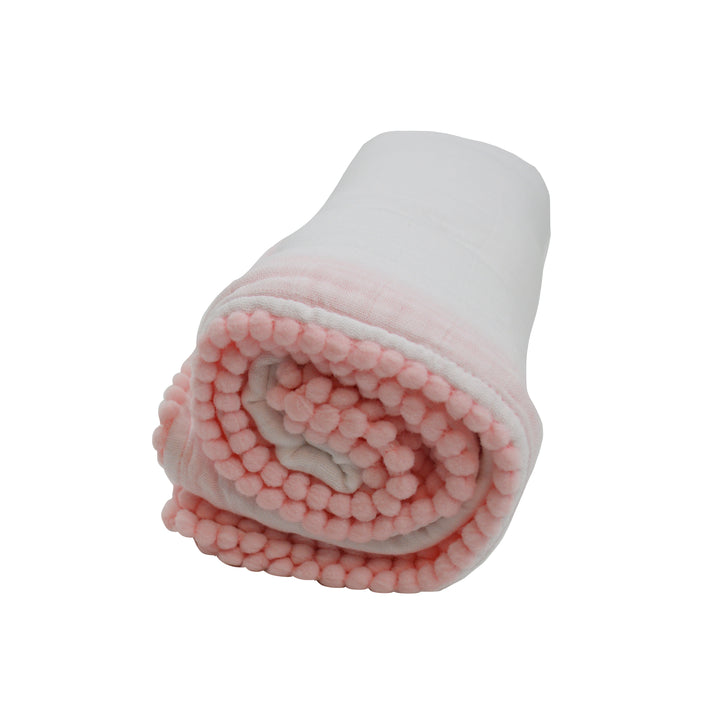 Rolled-up pink and white blanket on a white background
