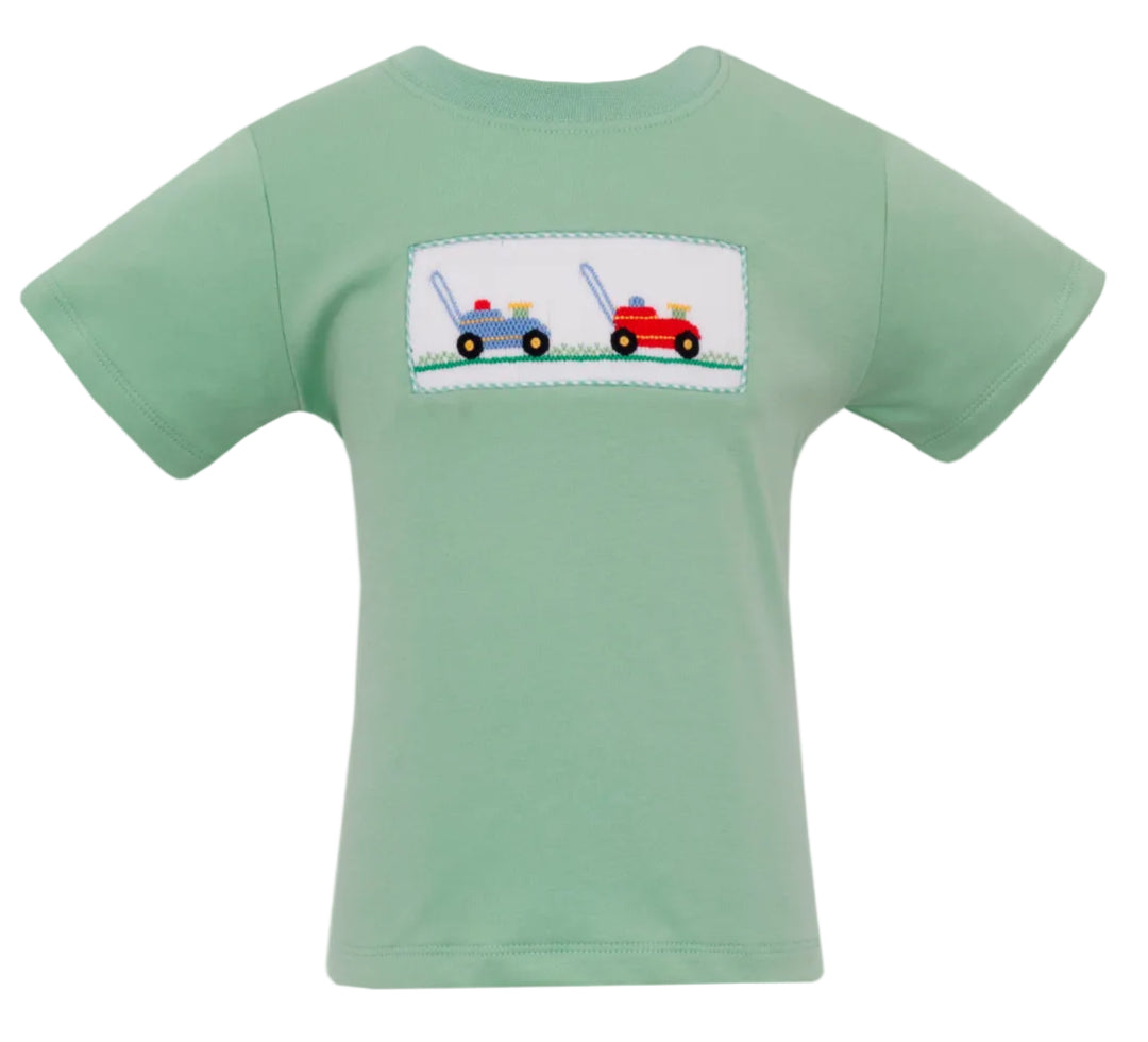 Green t-shirt with smocked design of lawn mowers on a white background