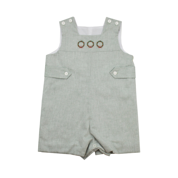 Green baby romper with embroidered wreath details on a white background