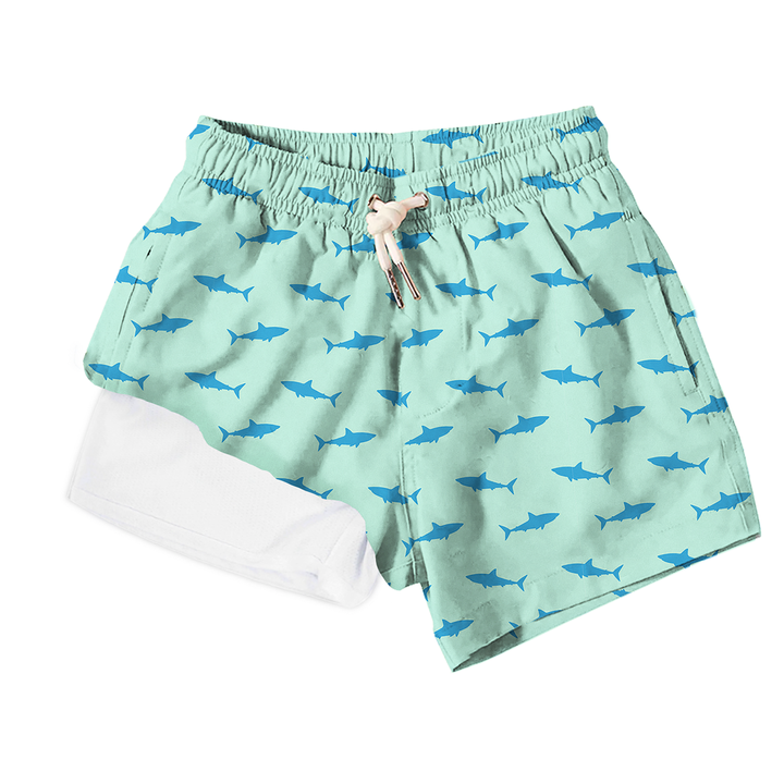 Green shorts with shark pattern on a white background
