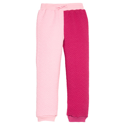 Pink and magenta quilted pants on a white background