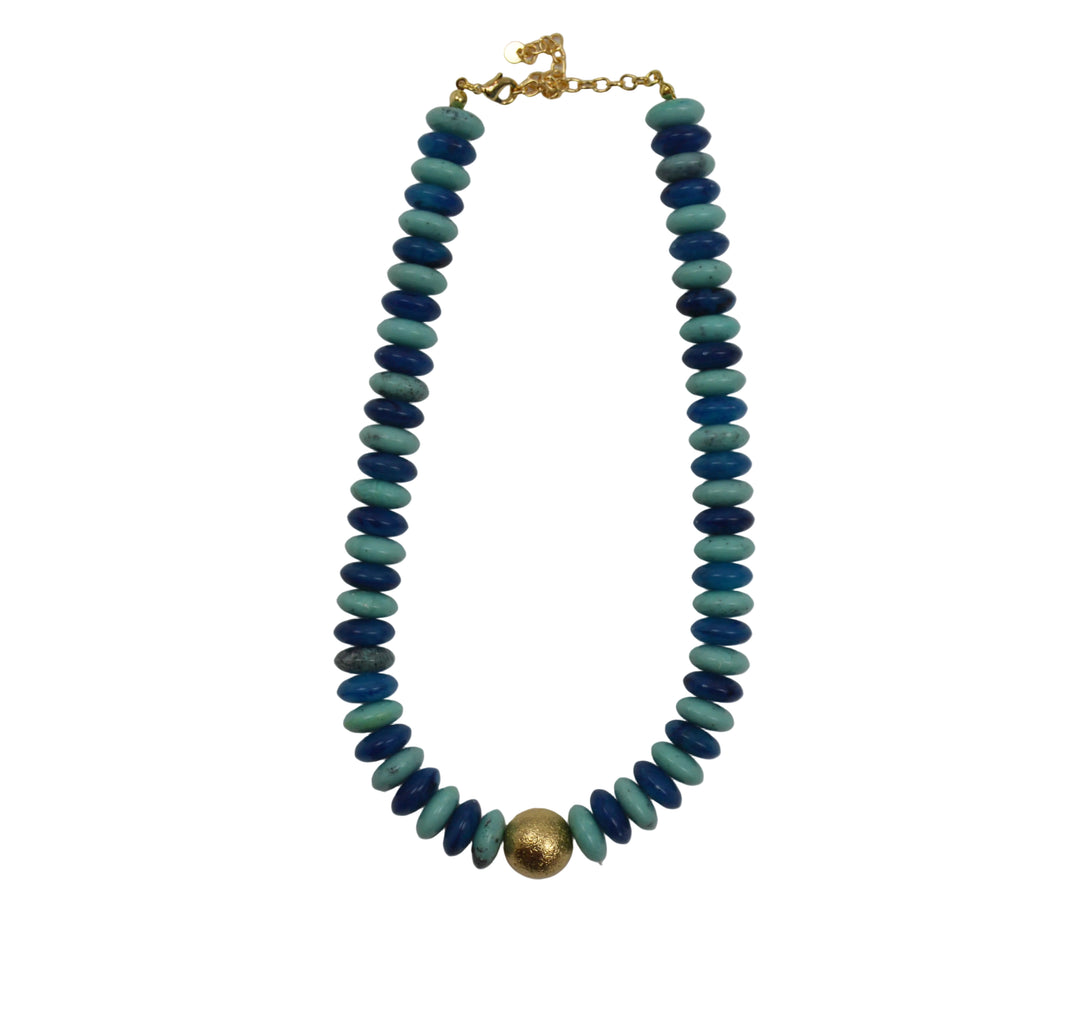 Necklace with blue beads and a gold clasp on a gray background