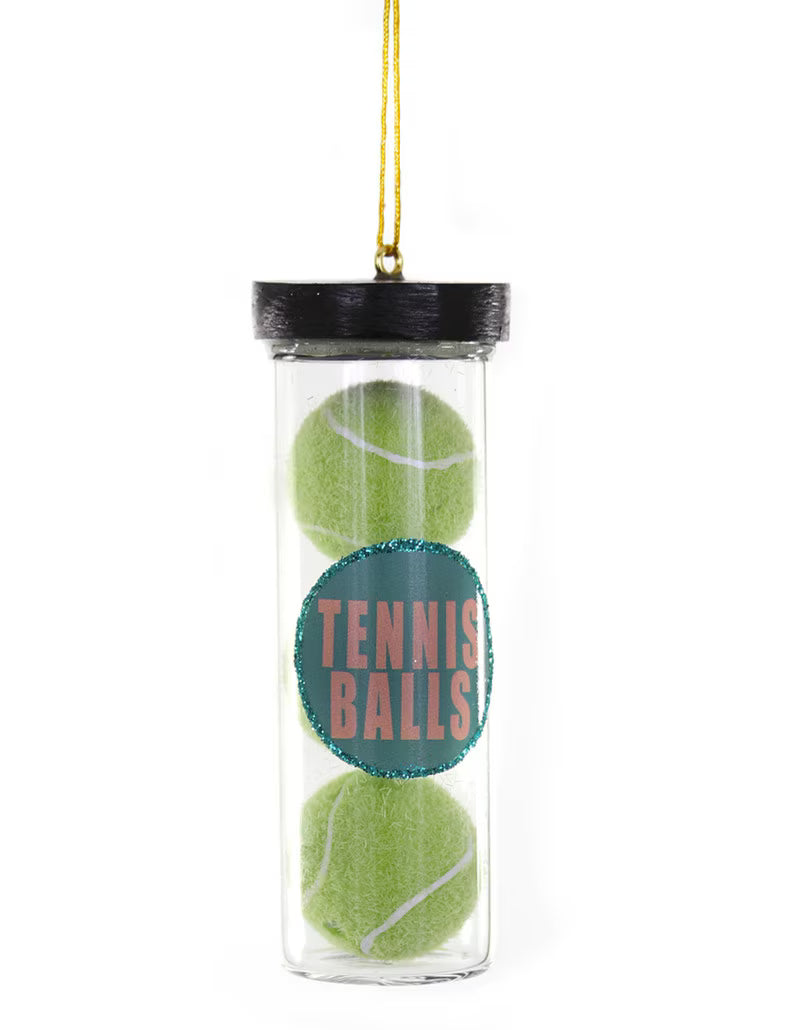 Clear container with two green tennis balls and a label on a white background