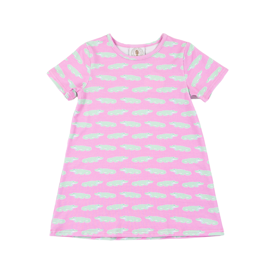 Pink dress with green alligator pattern on a white background