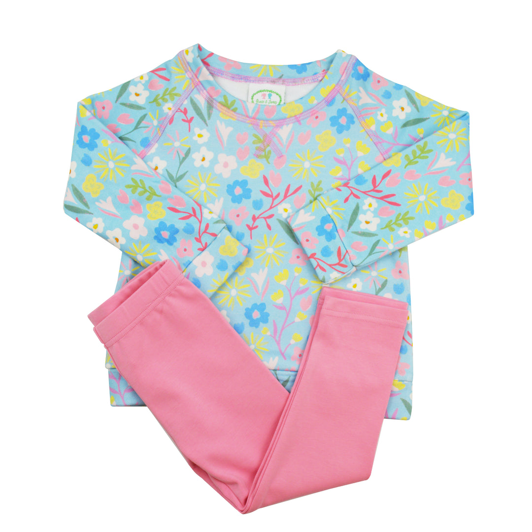 Children's legging set with floral top and pink pants on a white background