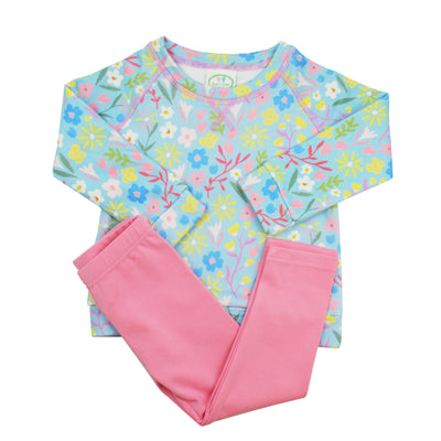 Children's legging set with floral top and pink pants on a white background