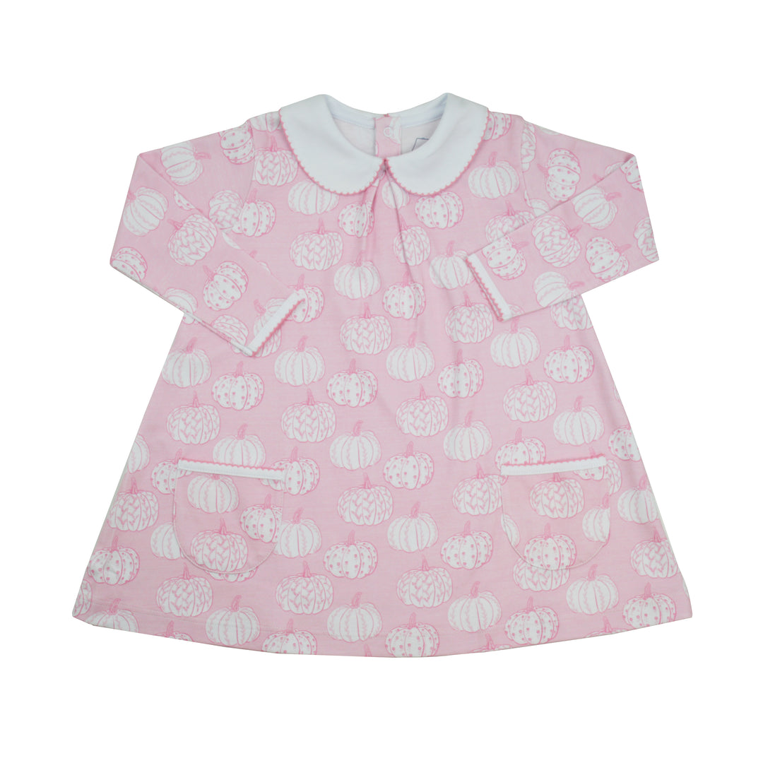A pink long-sleeve dress with a white pumpkin pattern, featuring a white Peter Pan collar, buttoned front, and two front patch pockets.