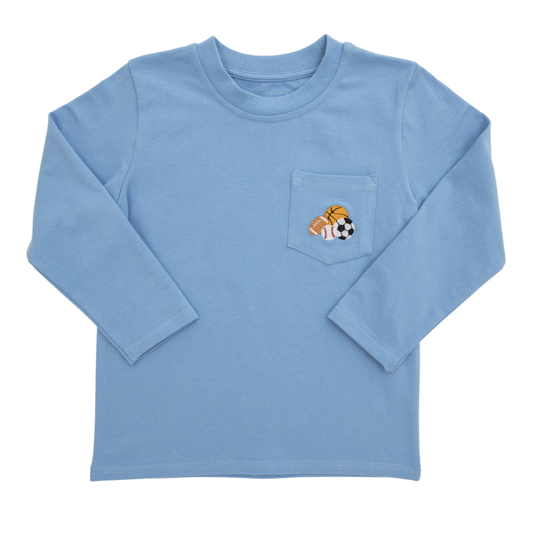 A light blue long-sleeve t-shirt with a chest pocket featuring a small embroidered graphic of a basketball, soccer ball, and football.