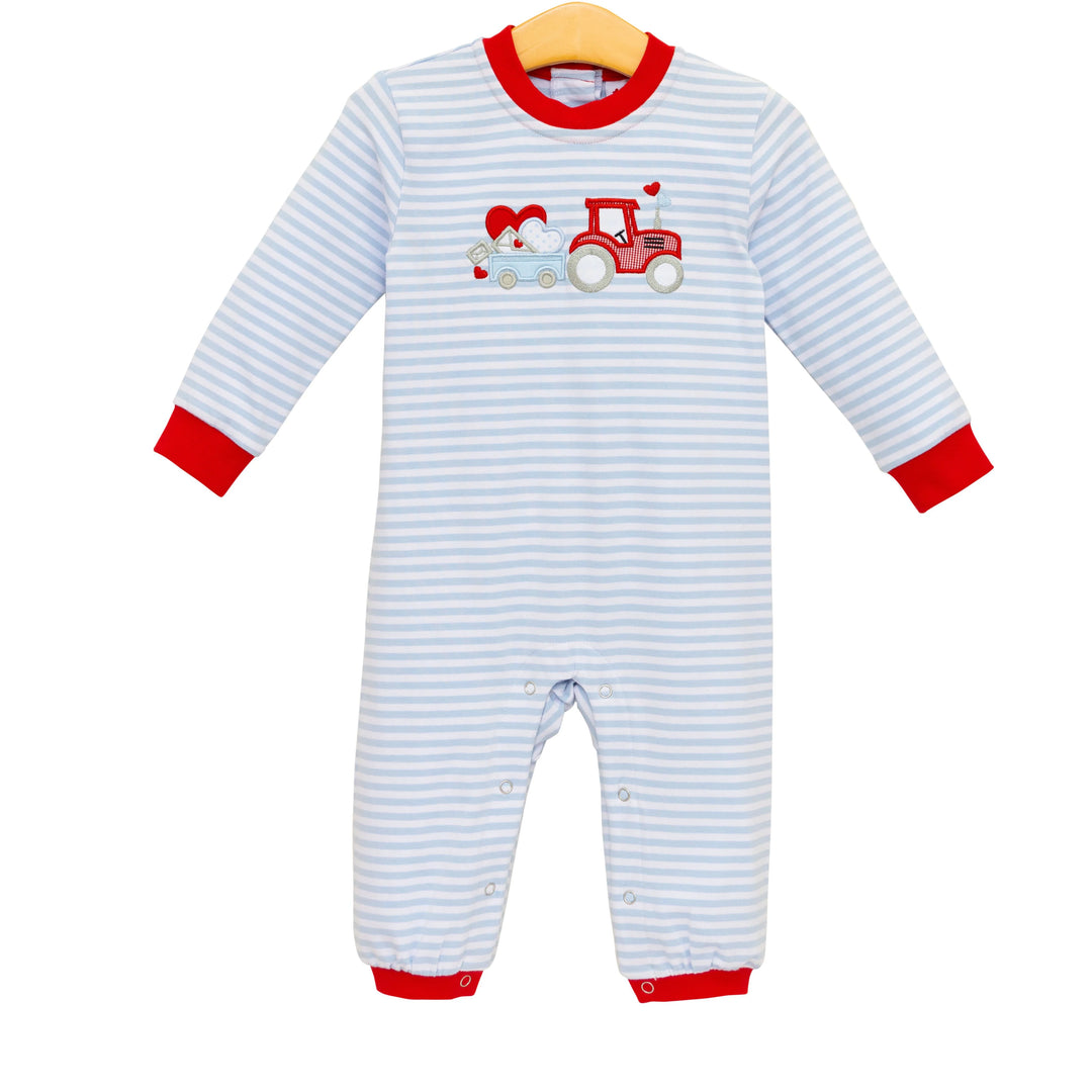 Striped baby onesie with a red tractor design on a white background