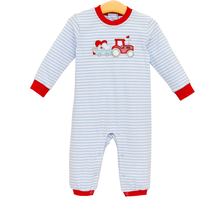 Striped baby onesie with a red tractor design on a white background