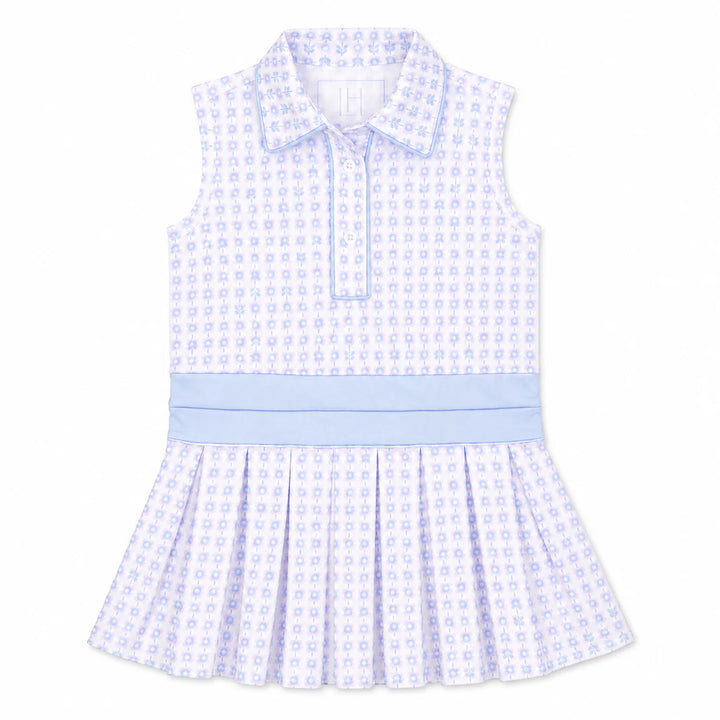 A sleeveless baby dress with a white base and light blue pattern, featuring a pointed collar, buttoned front, and a pleated skirt.