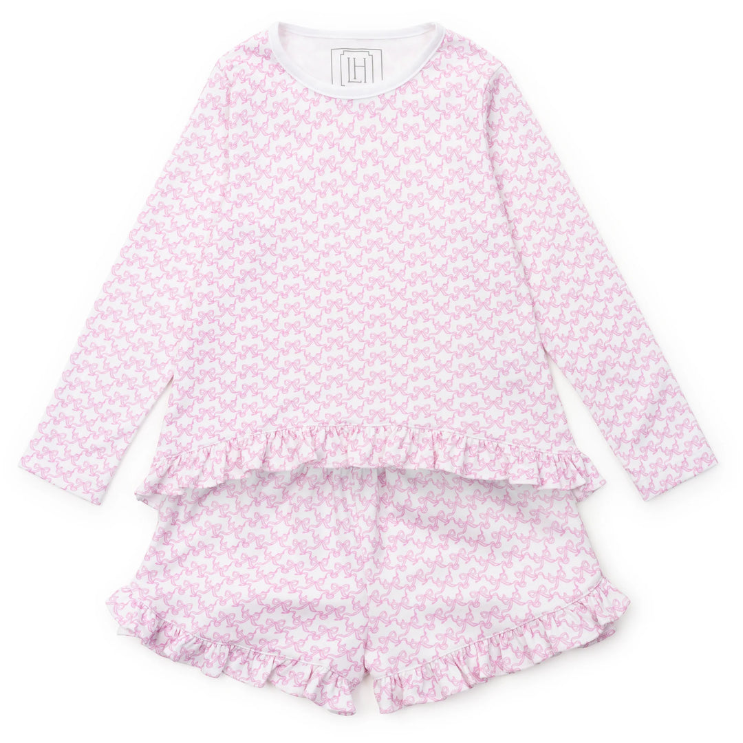 Pink bow pajama set with ruffled shorts on a white background