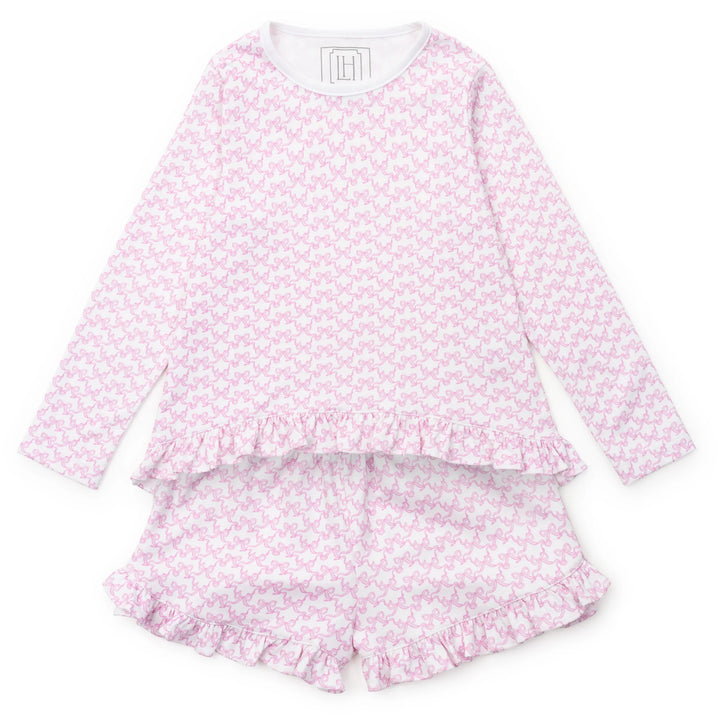 Pink bow pajama set with ruffled shorts on a white background