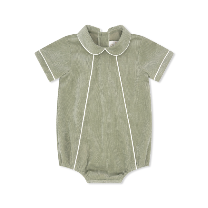 Green baby romper with white trim on a white background