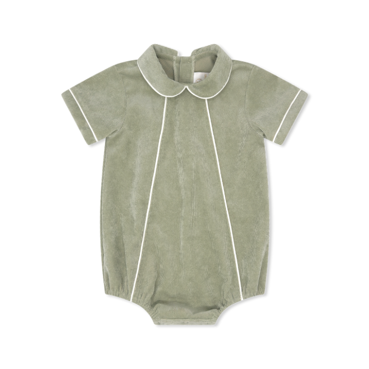 Green baby romper with white trim on a white background