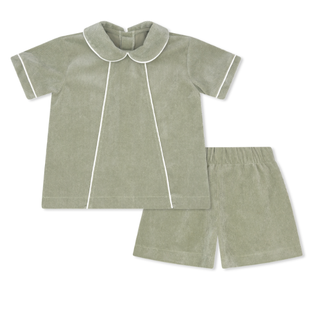 Green children's shirt and shorts set with white trim on a white background