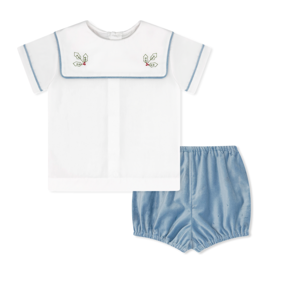 Children's outfit with white top and blue bloomers on a white background