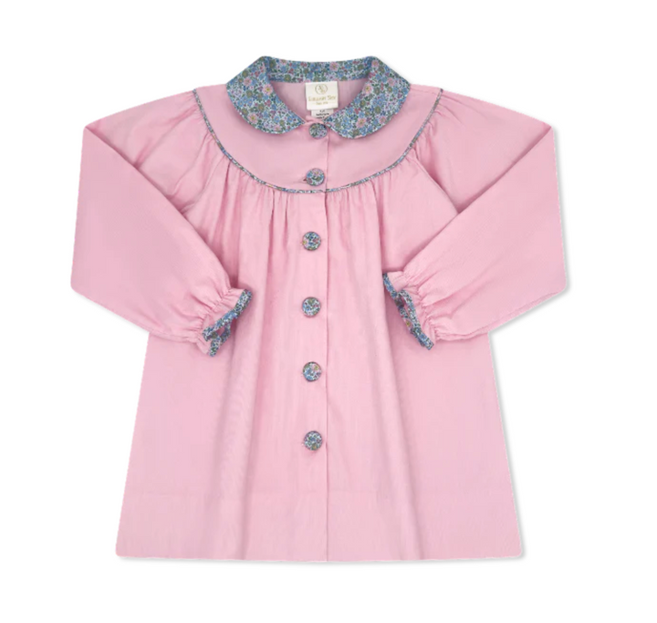 Pink children's dress with floral collar and cuffs on a white background