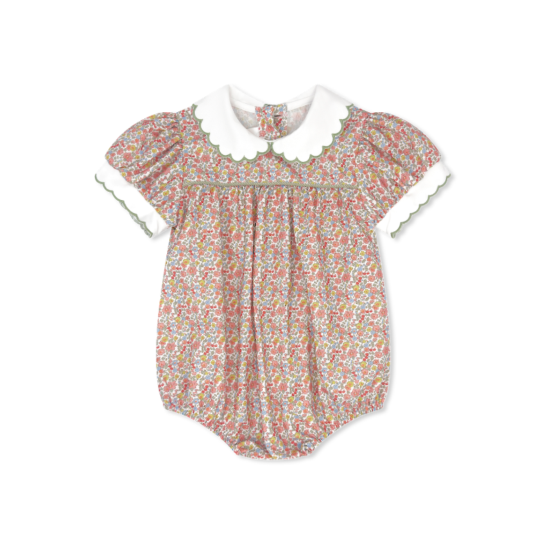 Floral baby romper with a white collar on a white background