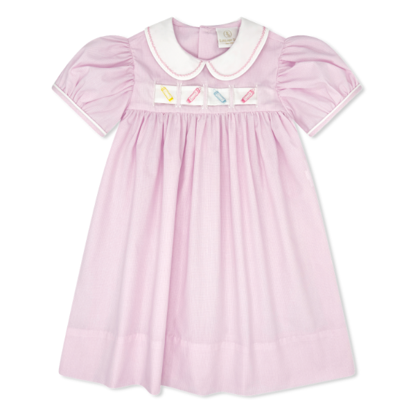 Pink dress with embroidered details on a white background