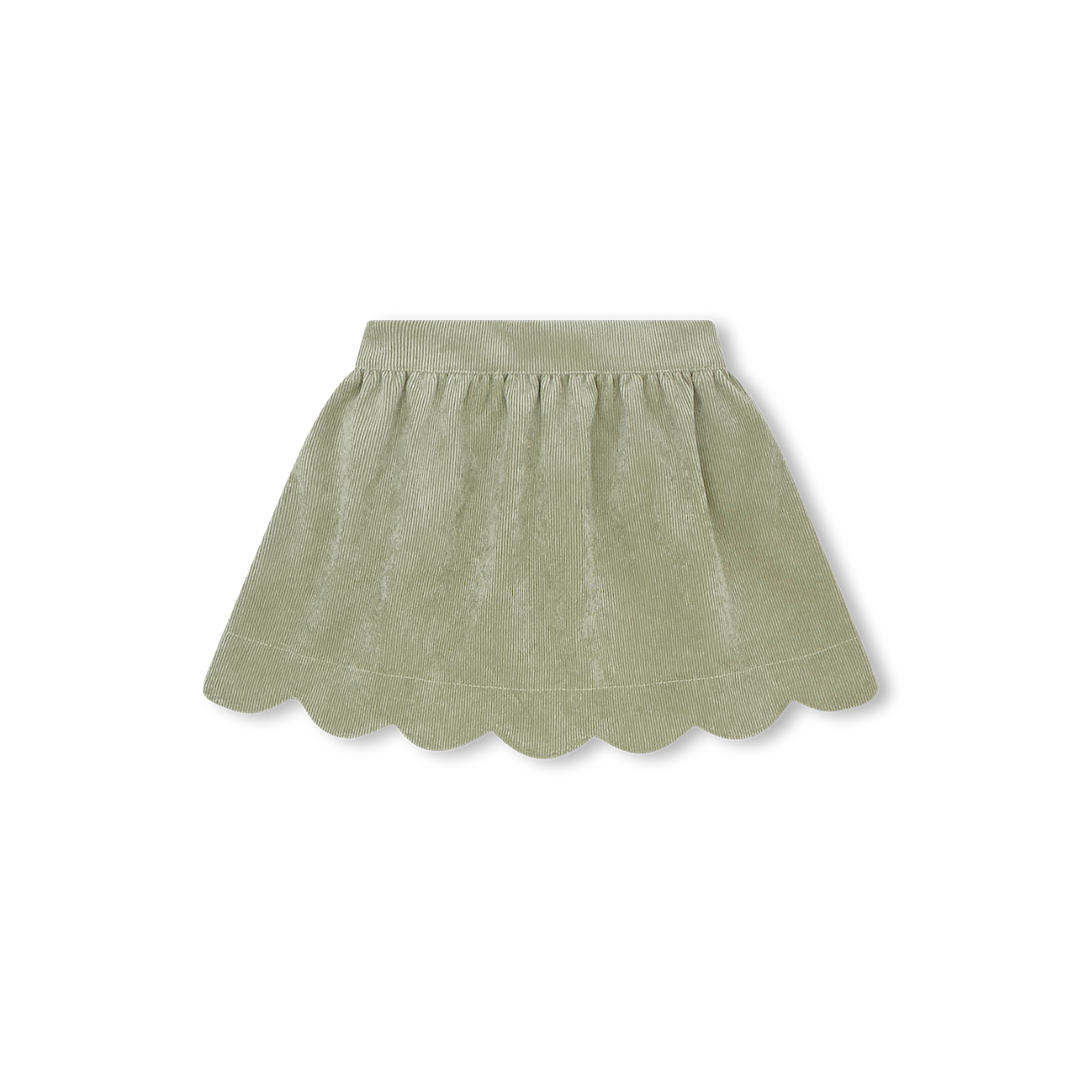 Green skirt with scalloped hem on a white background