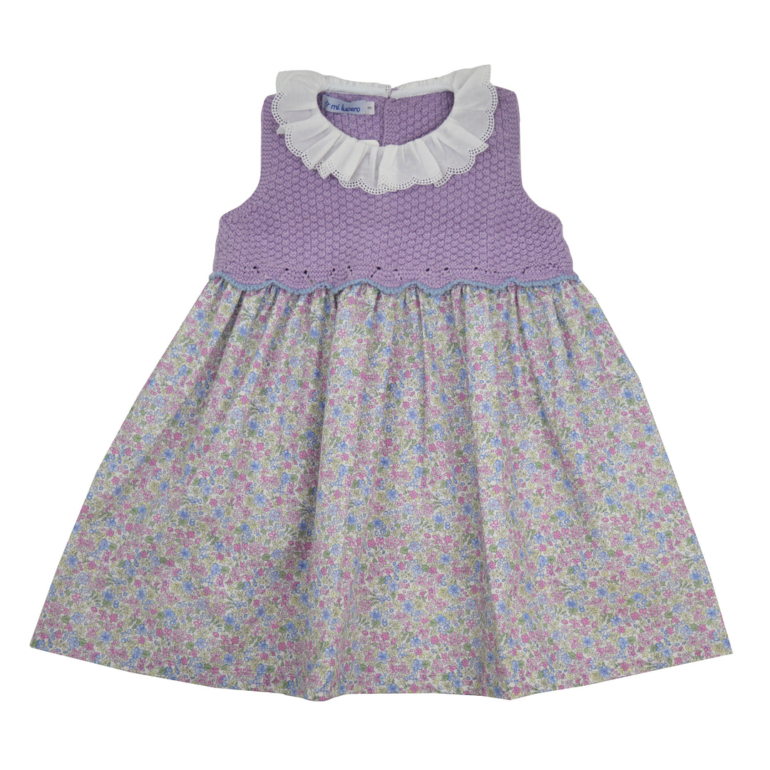 Children's dress with purple top and floral skirt on a white background
