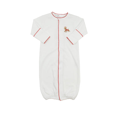 White baby gown with red stitching and a small embroidered reindeer design on a white background