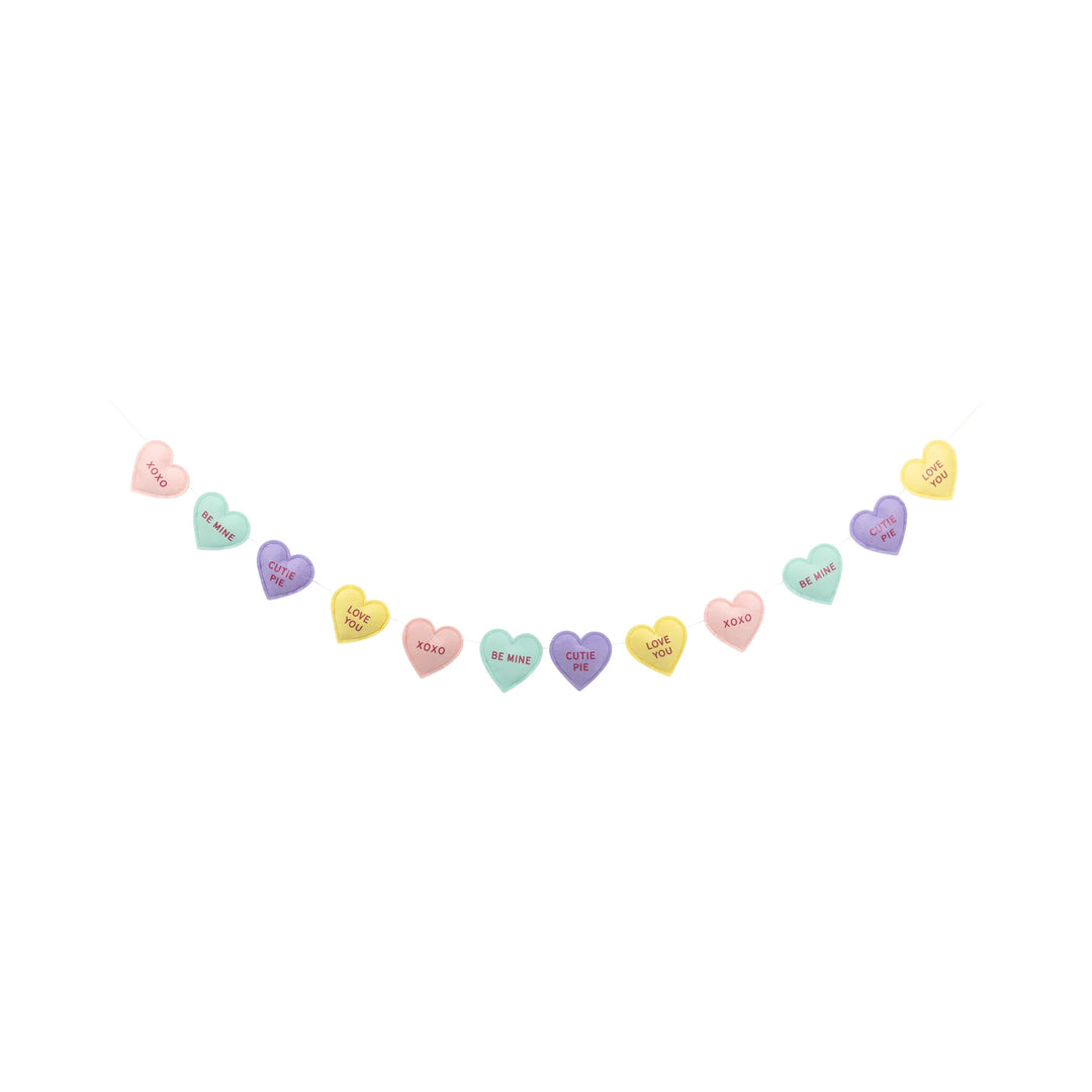 Colorful heart-shaped candy hearts banner on a white background
