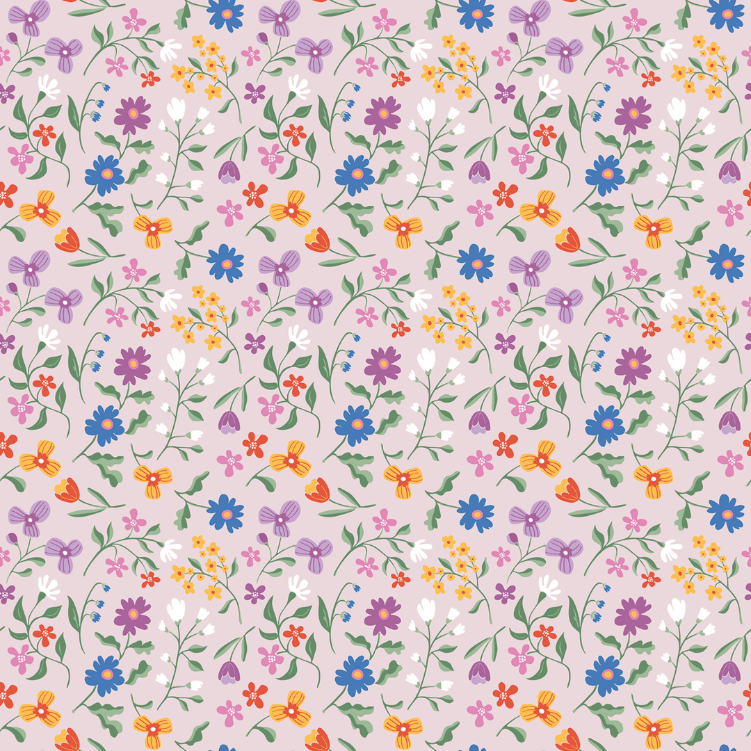 A seamless repeating floral pattern featuring a variety of small wildflowers in blue, purple, orange, pink, and white on a soft, pale pinkish-beige background.