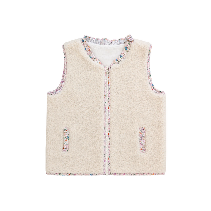 A sleeveless cream-colored fleece vest with multicolor speckled trim along the collar, front zipper, and pocket edges, shown flat on a light cream background.