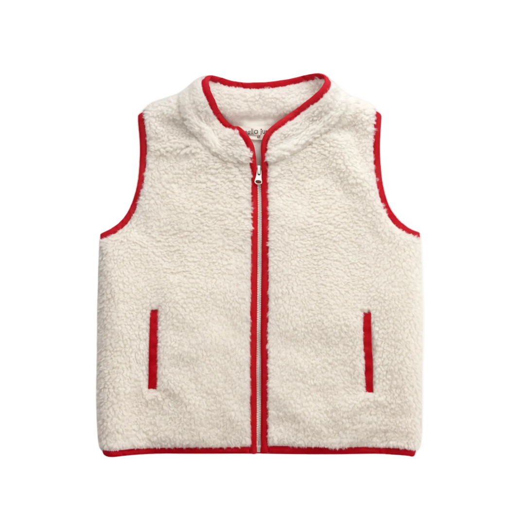 A cream-colored sherpa fleece vest with red trim, featuring a front zipper, two vertical zip pockets, and a ribbed collar, photographed flat against a light cream background.