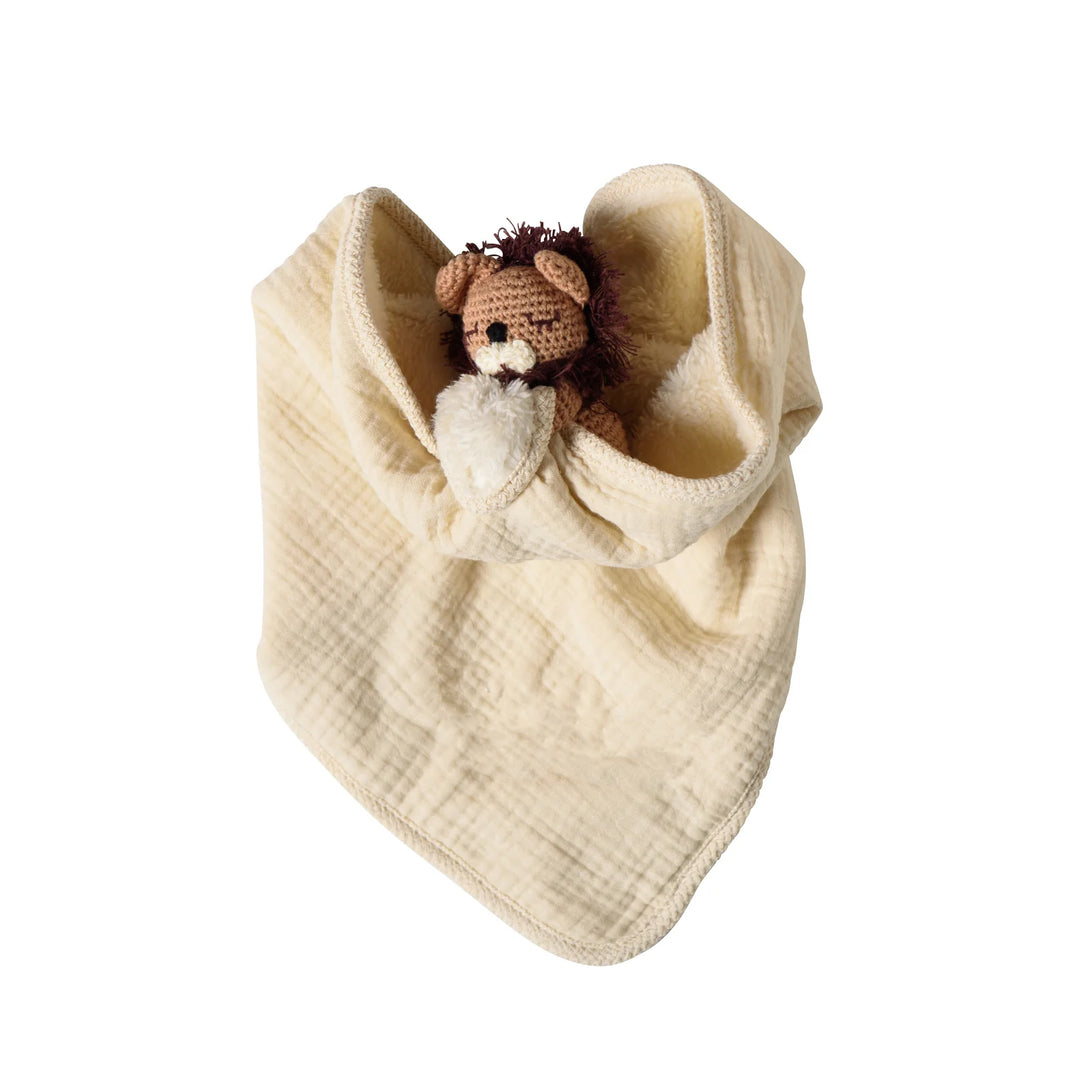 Baby blanket with a lion toy inside on a white background