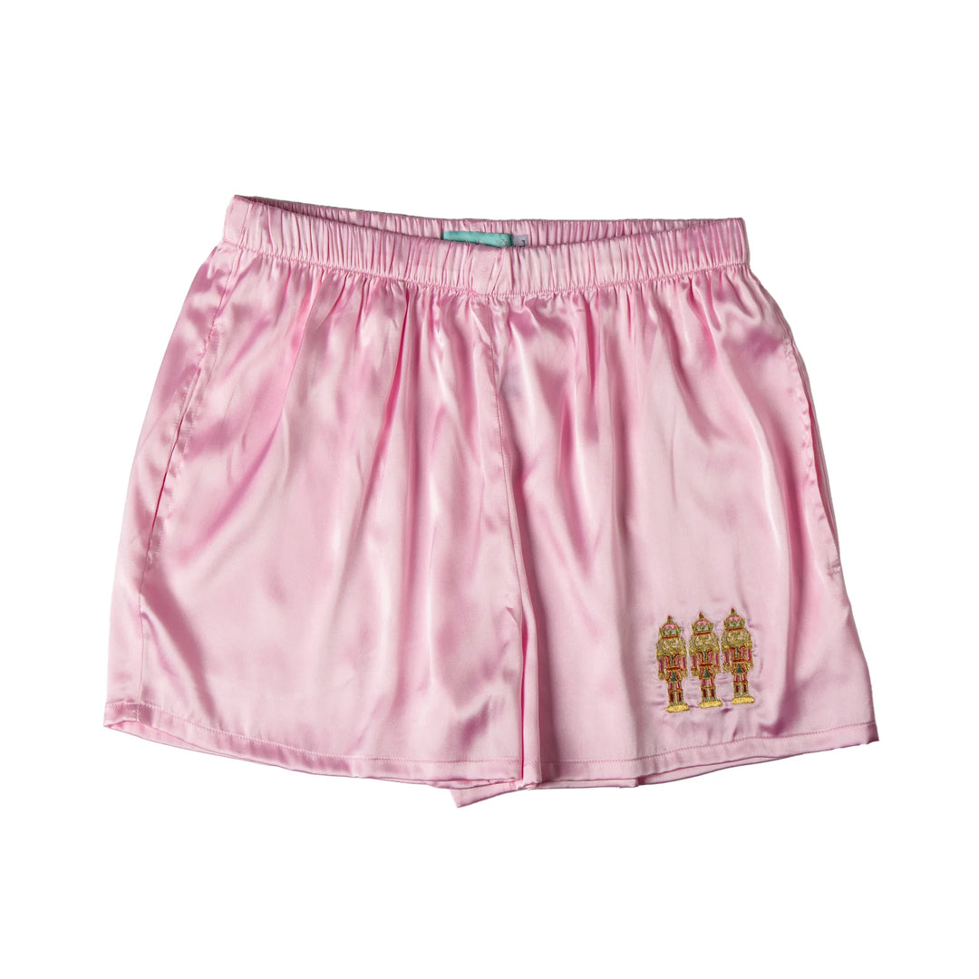 Pink shorts with a small embroidered nutcracker men design on a white background