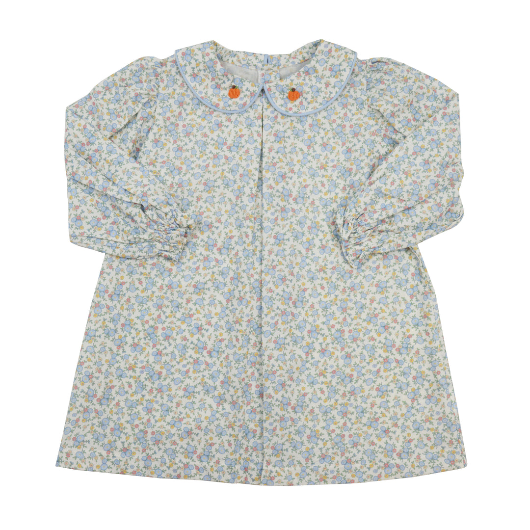 Floral patterned dress with long sleeves on a white background