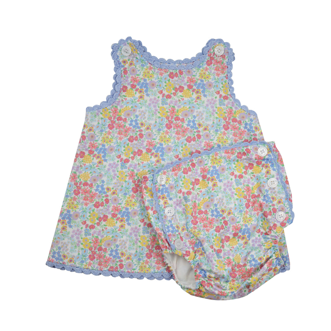 Floral baby romper with buttons on a white background