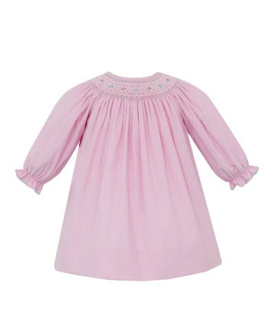 Pink dress with smocked neckline on a white background