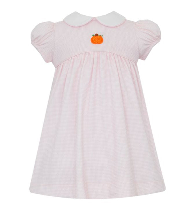 Pink dress with pumpkin embroidery on a white background