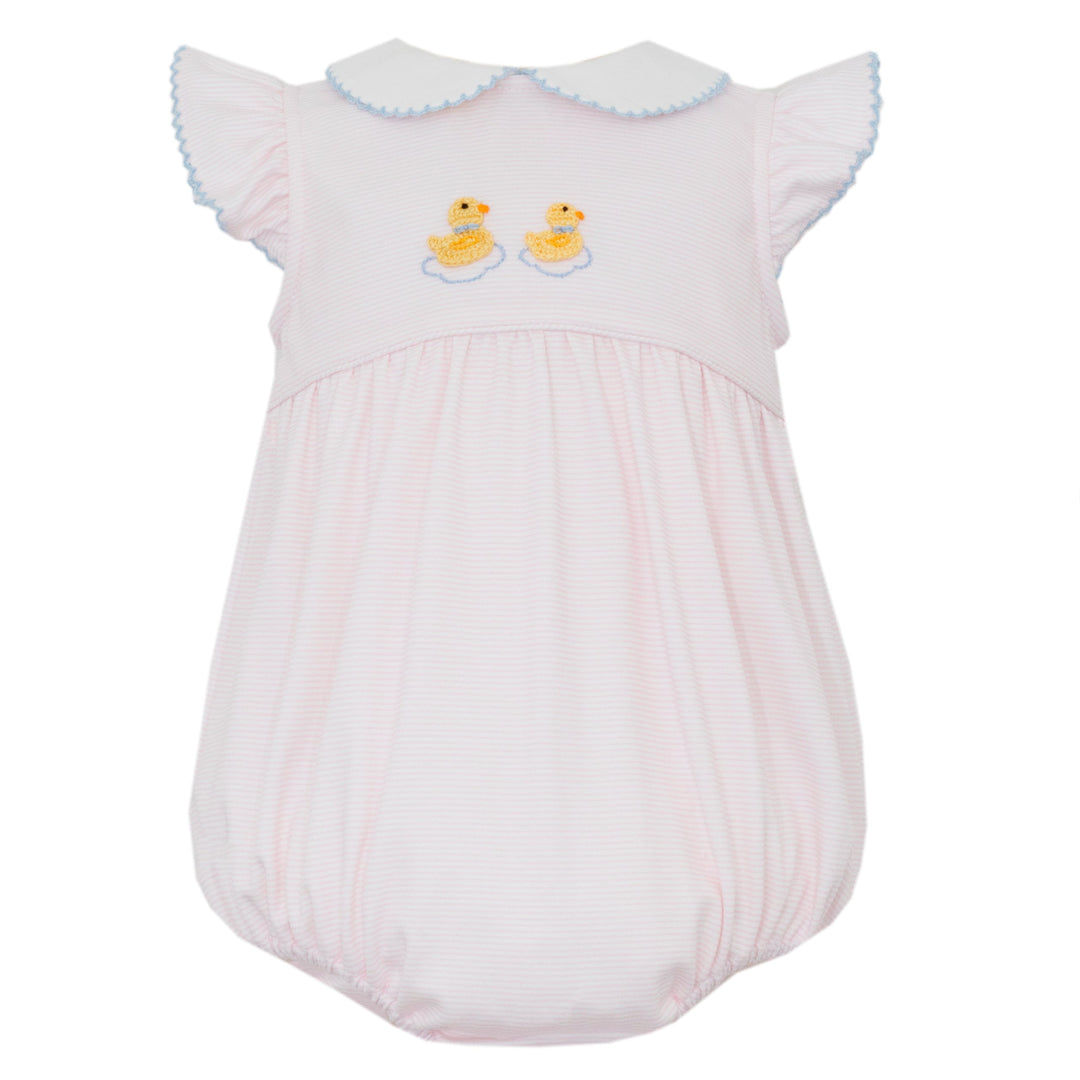 White baby romper with yellow duck designs on a white background
