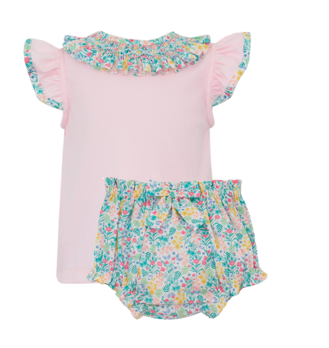Baby outfit with pink top and floral bloomers on a white background