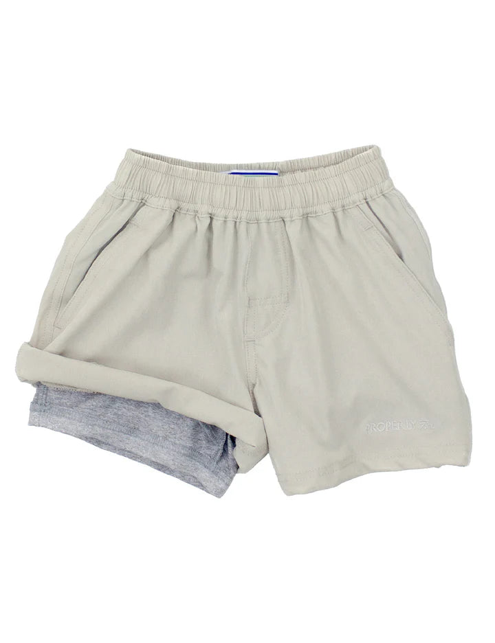 Pair of beige shorts on a white background