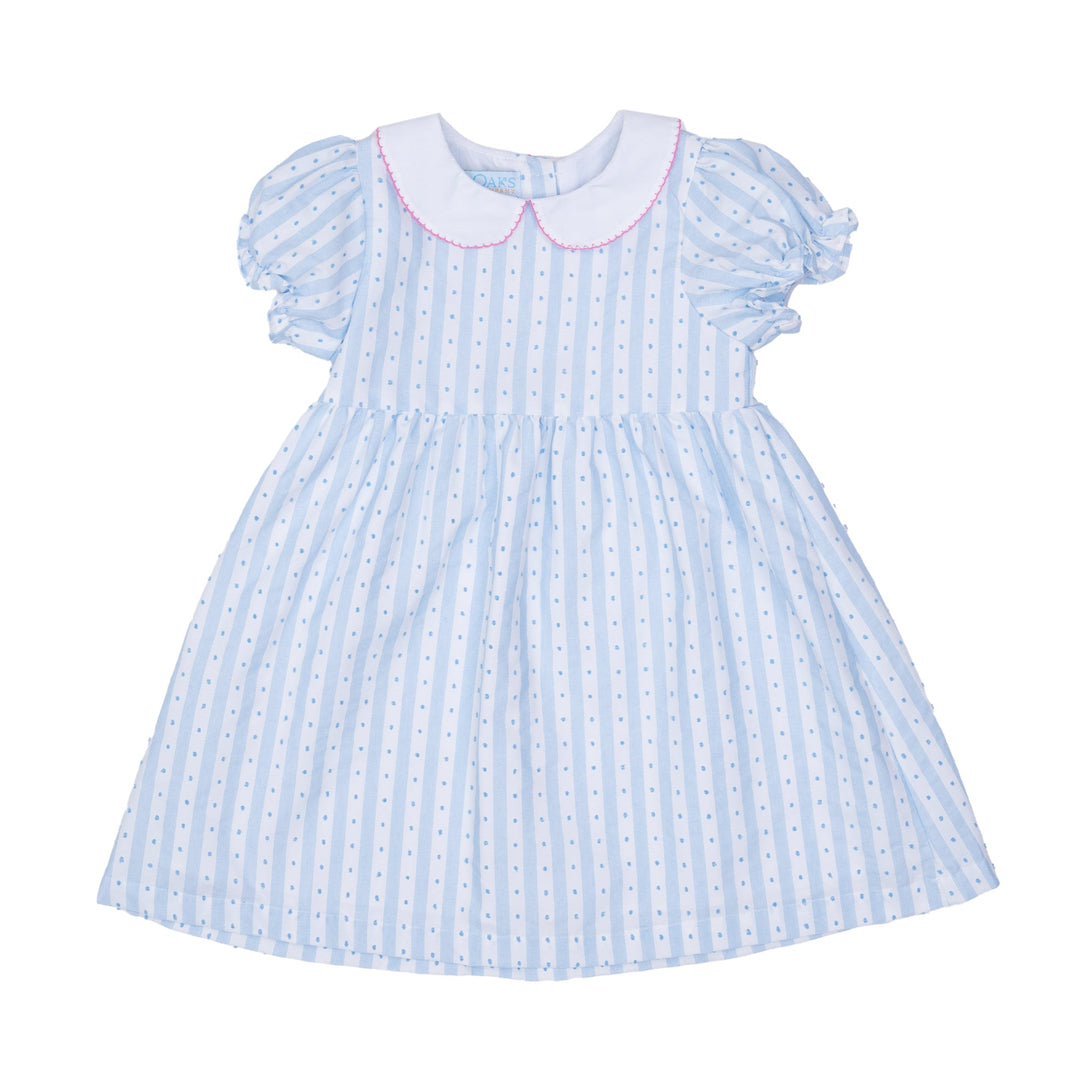 Light blue dress with white polka dots and pink collar on a white background