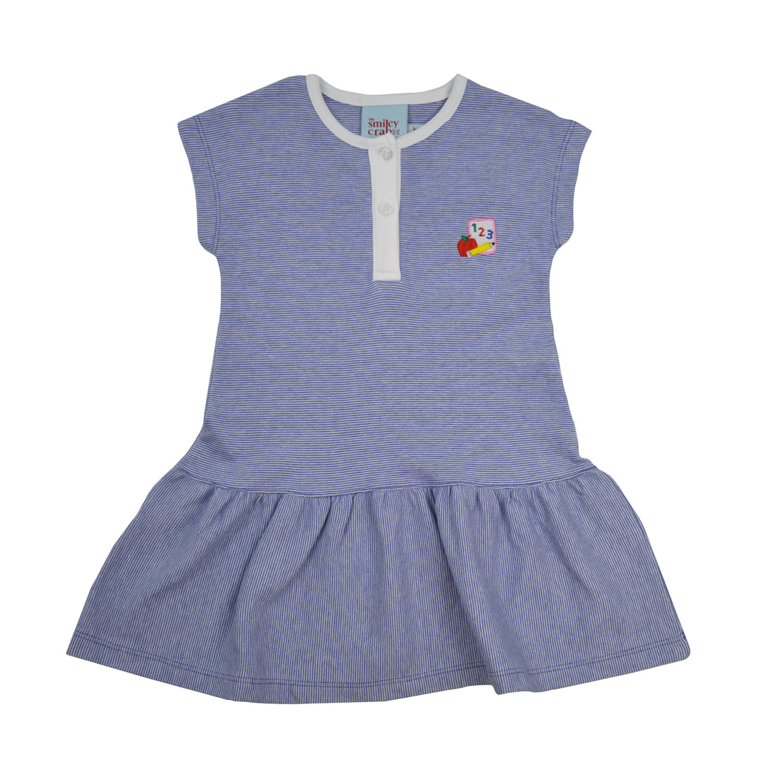 A girl dress in striped blue with a white collar and button placket, featuring a small colorful cartoon graphic on the chest. The dress has a ruffled hem and is photographed flat against a white background.