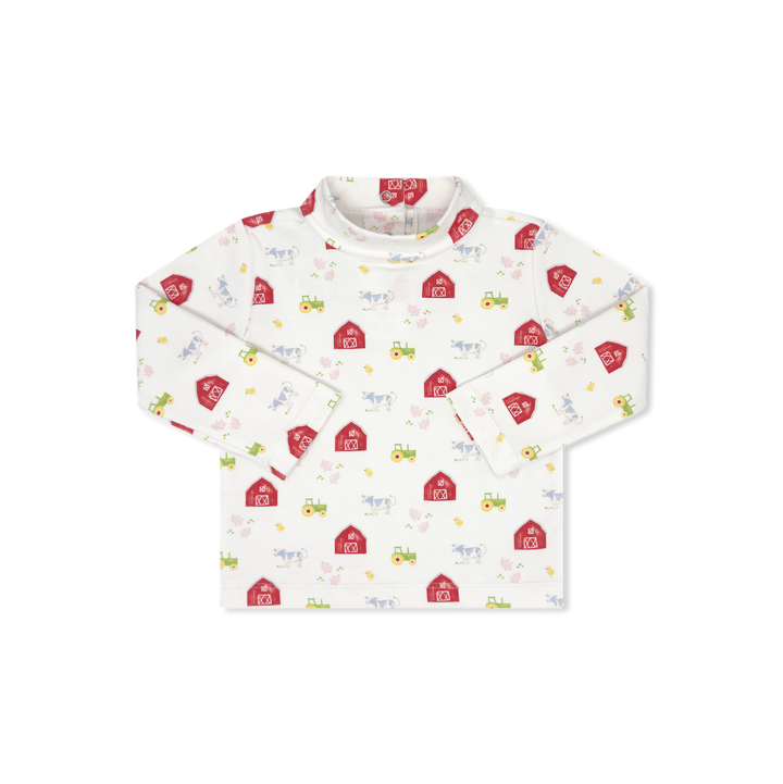 A long-sleeve baby shirt with a white base and a colorful print of red barns, yellow tractors, and small farm animals, shown flat on a white background.