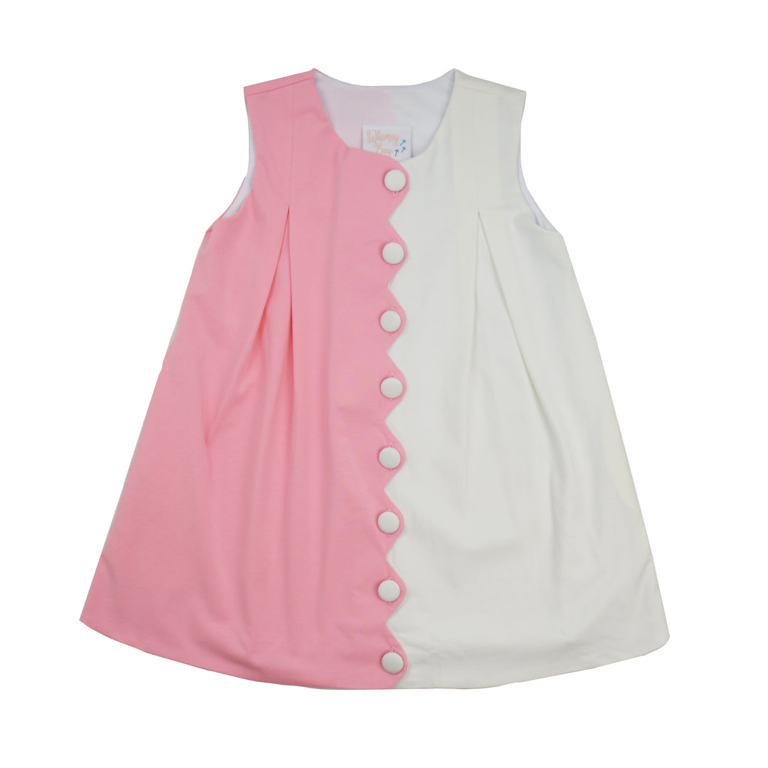 Pink and white dress with button details on a white background