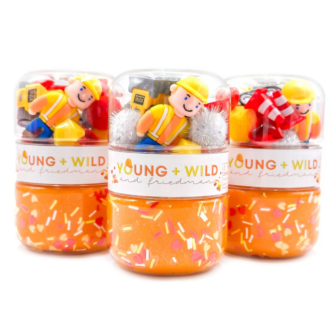 Three small jars with toy figures and colorful contents, branded 'Young & Wild'.